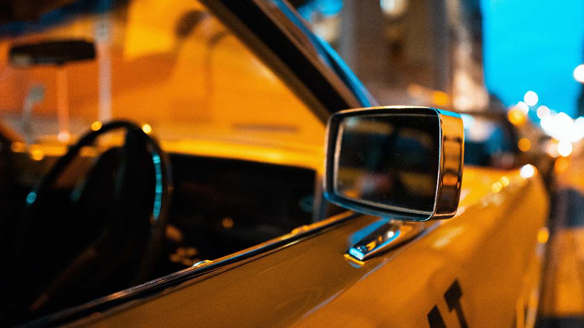 computer close-up photography of yellow car left side mirror electronics